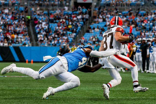 Cleveland Browns Luke Floriea runs with the ball as Carolina Panthers left back Krys Barnes tackles him during the preseason game between the Cleveland Browns and the Carolina Panthers at Bank of America Stadium in Charlotte, NC, Friday August 8, 2025. 