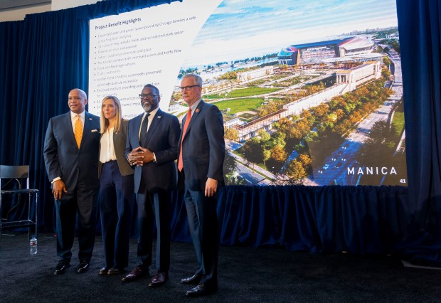 Bears President and CEO Kevin Warren; Karen Murphy, executive vice president of stadium development; Mayor Brandon Johnson; and Chairman George McCaskey stand in front of a rendering after the Bears announced their plans to build a new domed lakefront stadium April 24, 2024, at Soldier Field. (Brian Cassella/Chicago Tribune)