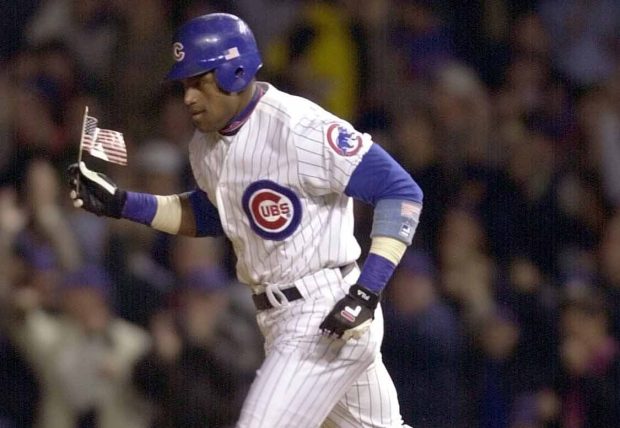 Cubs slugger Sammy Sosa carries an American flag around the bases after hitting a home run against the Astros on Sept. 27, 2001, at Wrigley Field. (JAMES PRISCHING/CHICAGO TRIBUNE)
