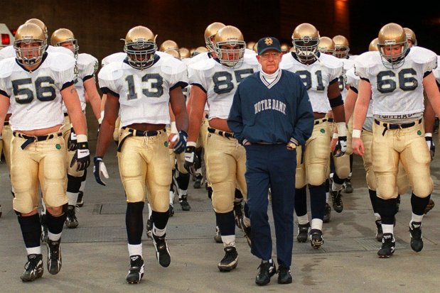Coach Lou Holtz leads his Notre Dame team onto the field for a game against USC at the Los Angeles Coliseum on Nov. 30, 1996, in Los Angeles. (Kevork Djansezian/AP file)
