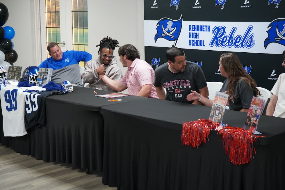 Gabriel Mendez (Center) is congratulated after he signed to play football at Maryville College...