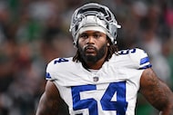 Dallas Cowboys defensive end Sam Williams (54) looks on during pre-game warm-ups before an...