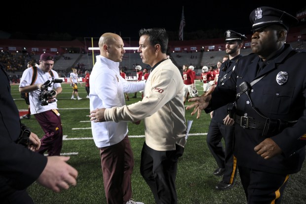 Minnesota head coach P.J. Fleck, middle left, and Rutgers interim head coach Nunzio Campanile shake hands after the visiting Golden Gophers won, 42-7, at SHI Stadium in Piscataway, N.J., on Saturday, Oct. 19, 2019.