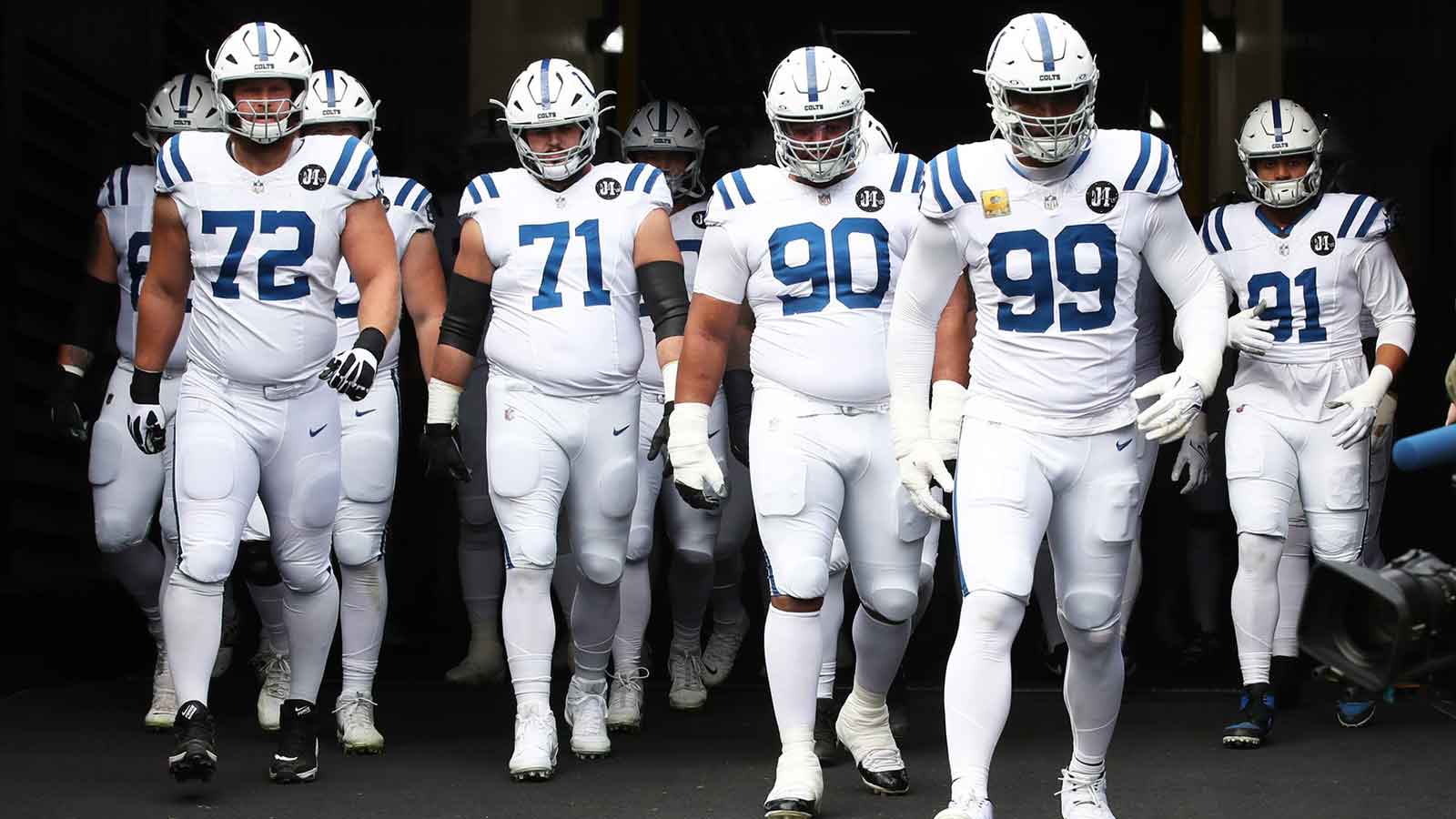 Indianapolis Colts offensive tackle Braden Smith (72) and offensive tackle Matt Goncalves (71) and defensive tackle Grover Stewart (90) and defensive tackle Deforest Buckner (99) and defensive end JT Tuimoloau (91) take the field to play the Pittsburgh Steelers at Acrisure Stadium.
