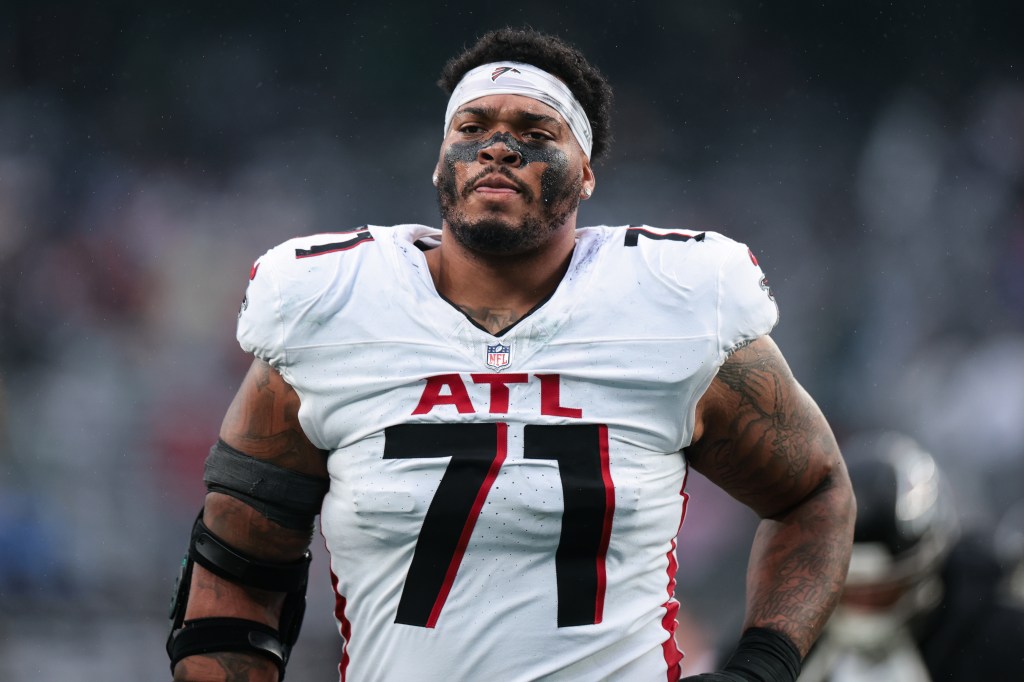 Elijah Wilkinson #71 of the Atlanta Falcons runs off the field for halftime during a game against the New York Jets at MetLife Stadium on November 30, 2025 in East Rutherford, New Jersey.  