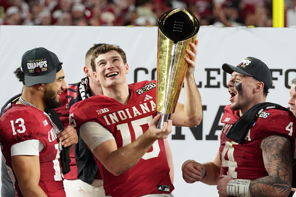 Indiana quarterback Fernando Mendoza holds the trophy after their win against Miami in the...