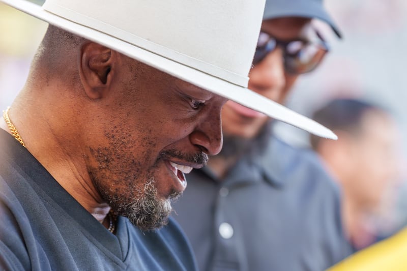 Closeup profile shot of actor/singer Jamie Foxx at BMO Stadium wearing quite a large hat.
