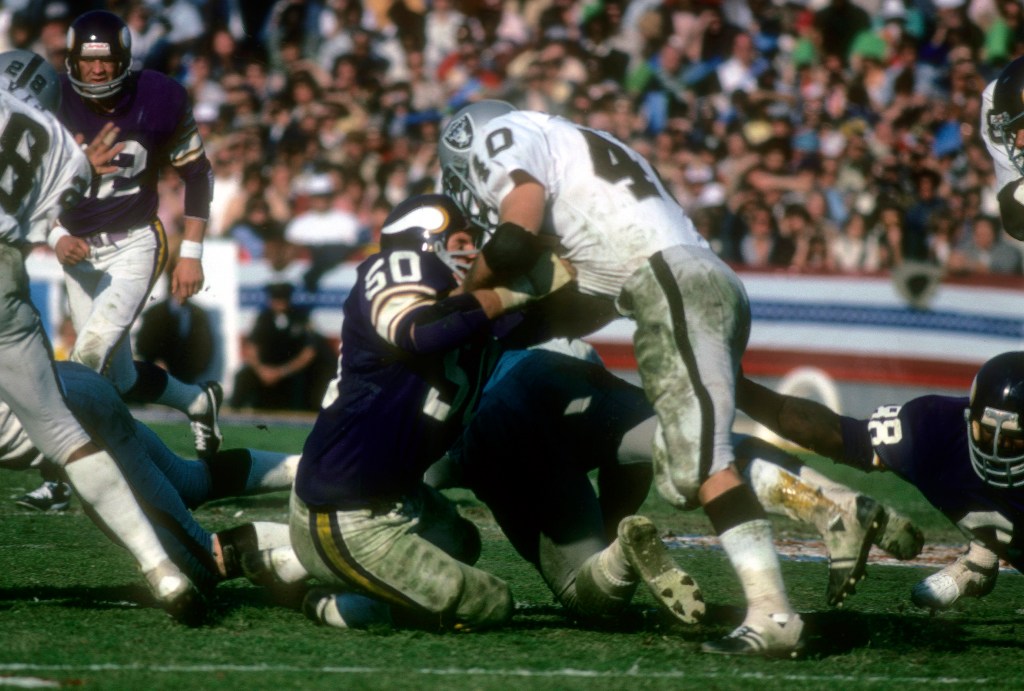 unning back Pete Banaszak #40 of the Oakland Raiders is hit by Jeff Siemon #50 of the Minnesota Vikings during Super Bowl XI on January 9, 1977 at the Rose Bowl in Pasadena, California.