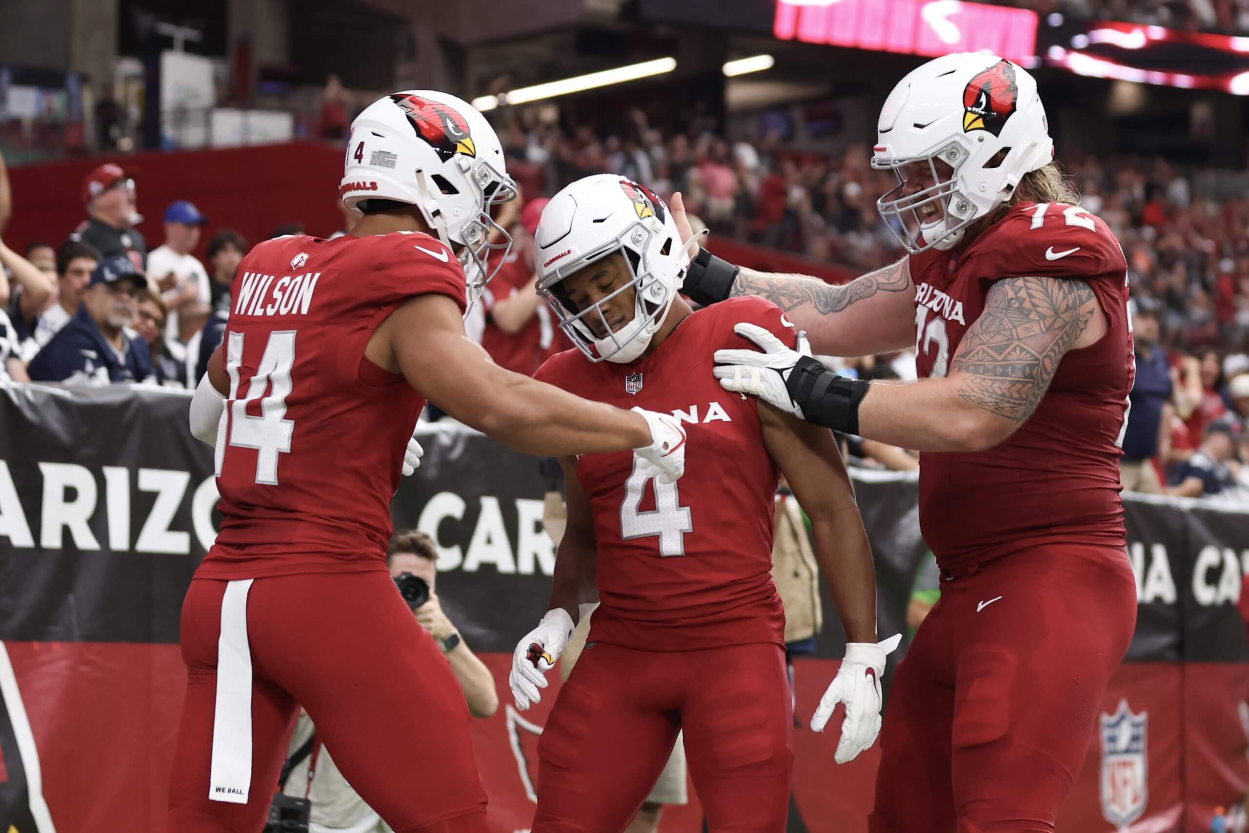 Rondale Moore (4) celebrates a touchdown with Arizona Cardinals teammates Michael Wilson and Hjalte Froholdt in 2023. (Christian Petersen / Getty Images)