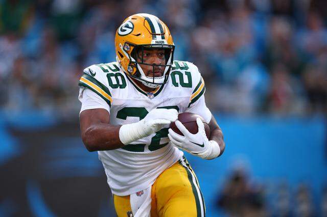 AJ Dillon carries the ball for the Packers during a game against the Carolina Panthers at Bank of America Stadium on Dec. 24, 2023 in Charlotte.