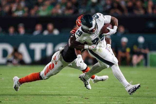 AJ Dillon, right, of the Philadelphia Eagles, carries the ball against Oren Burks of the Cincinnati Bengals in a preseason game at Lincoln Financial Field on Aug. 7, 2025 in Philadelphia.
