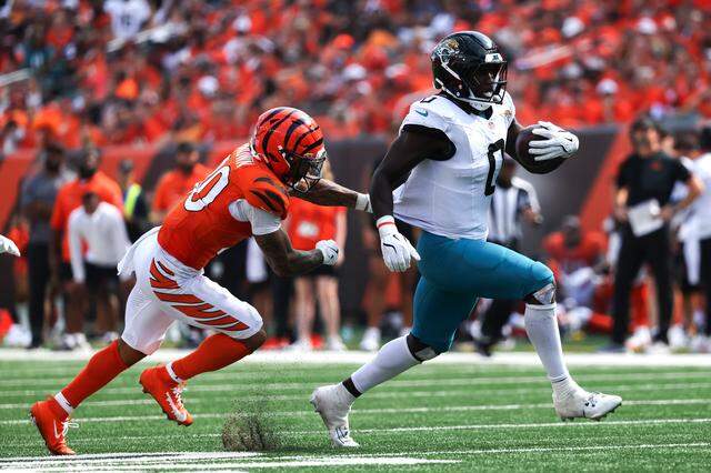 Jacksonville linebacker Devin Lloyd returns an interception against Chase Brown of the Cincinnati Bengals during a 2025 game in Cincinnati.