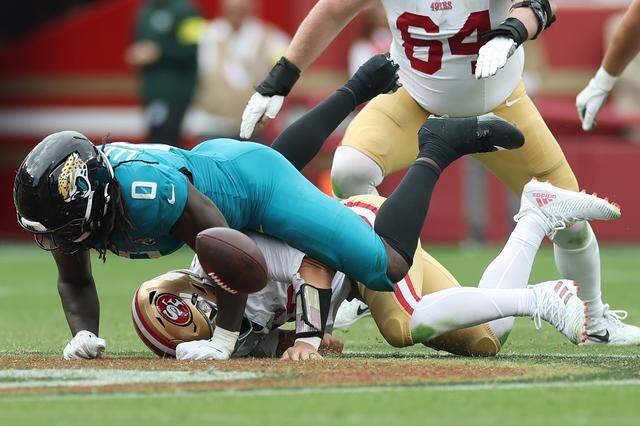 Jacksonville Jaguars linebacker Devin Lloyd tackles San Francisco 49ers quarterback Brock Purdy, forcing a fumble, during a 2025 game in Santa Clara, California.