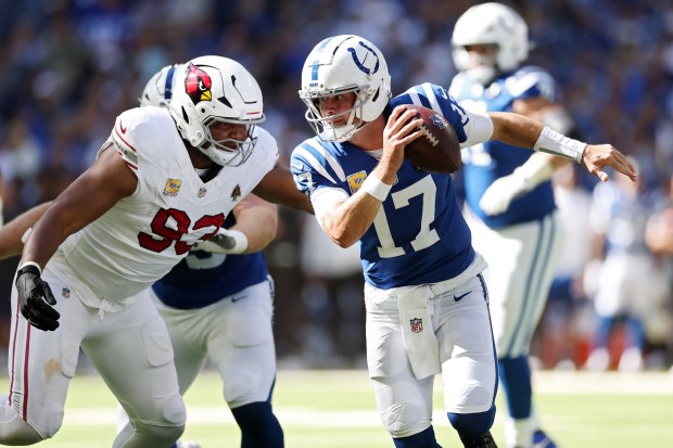 Daniel Jones of the Indianapolis Colts runs from Calais Campbell of the Arizona Cardinals during the first quarter at Lucas Oil Stadium on October 12, 2025 in Indianapolis, Indiana. (Photo by Andy Lyons/Getty Images)