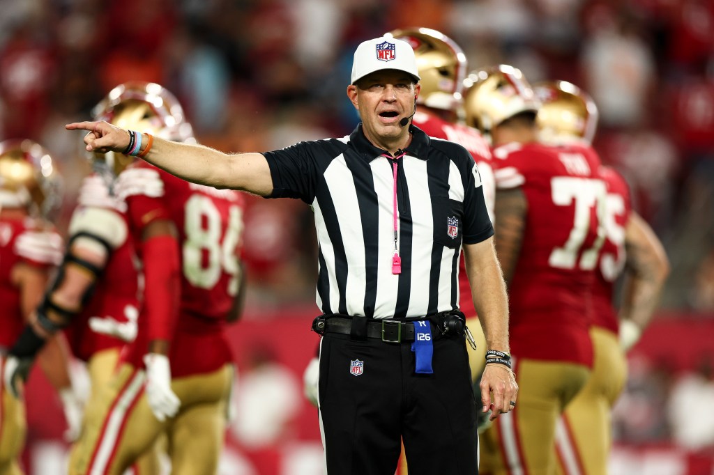 Referee Brad Rogers #126 calls a penalty during an NFL football game between the Tampa Bay Buccaneers and the San Francisco 49ers at Raymond James Stadium on October 12, 2025 in Tampa, Florida.
