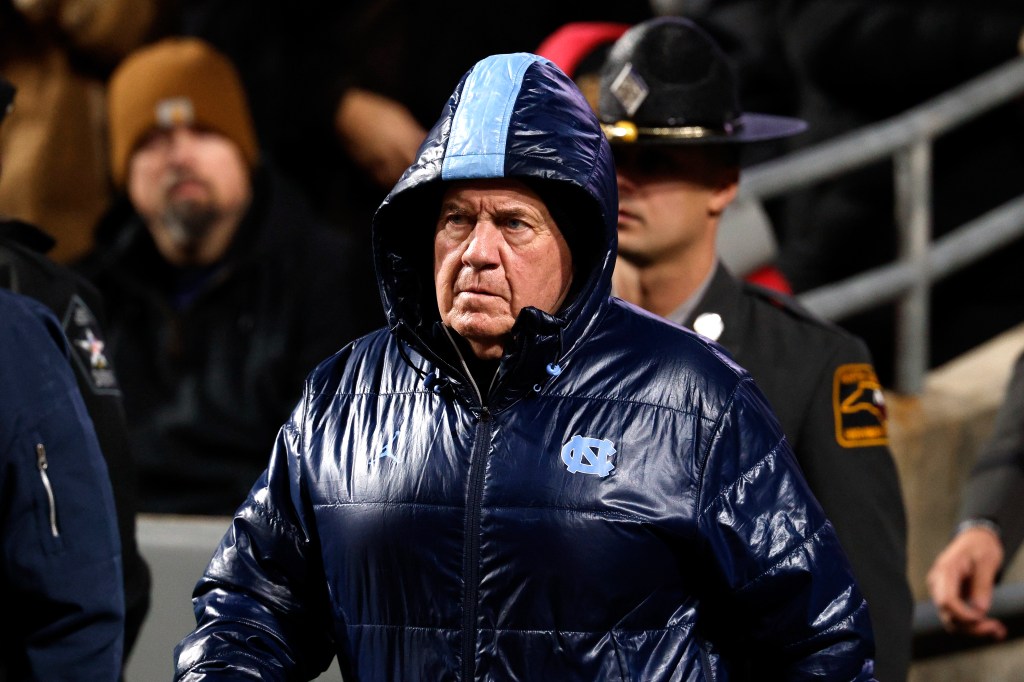 Head coach Bill Belichick of the North Carolina Tar Heels walks onto the field prior to the game against the NC State Wolfpack