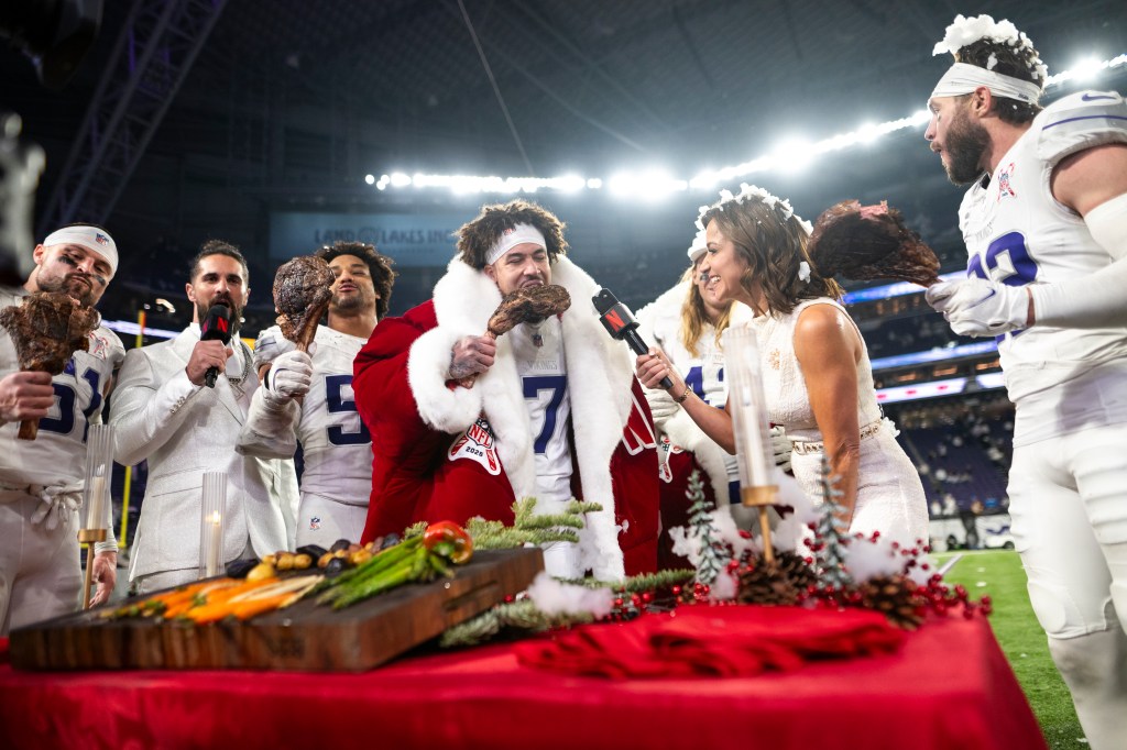 Byron Murphy Jr. #7 of the Minnesota Vikings takes a bite of steak as he is interviewed by Diana Russini on Netflix after the game against the Detroit Lions at U.S. Bank Stadium on December 25, 2025 in Minneapolis, Minnesota. 