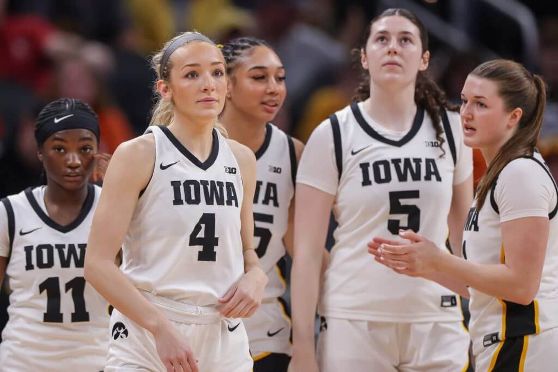 Kylie Feuerbach and her teammates look on during Iowa's first round game.