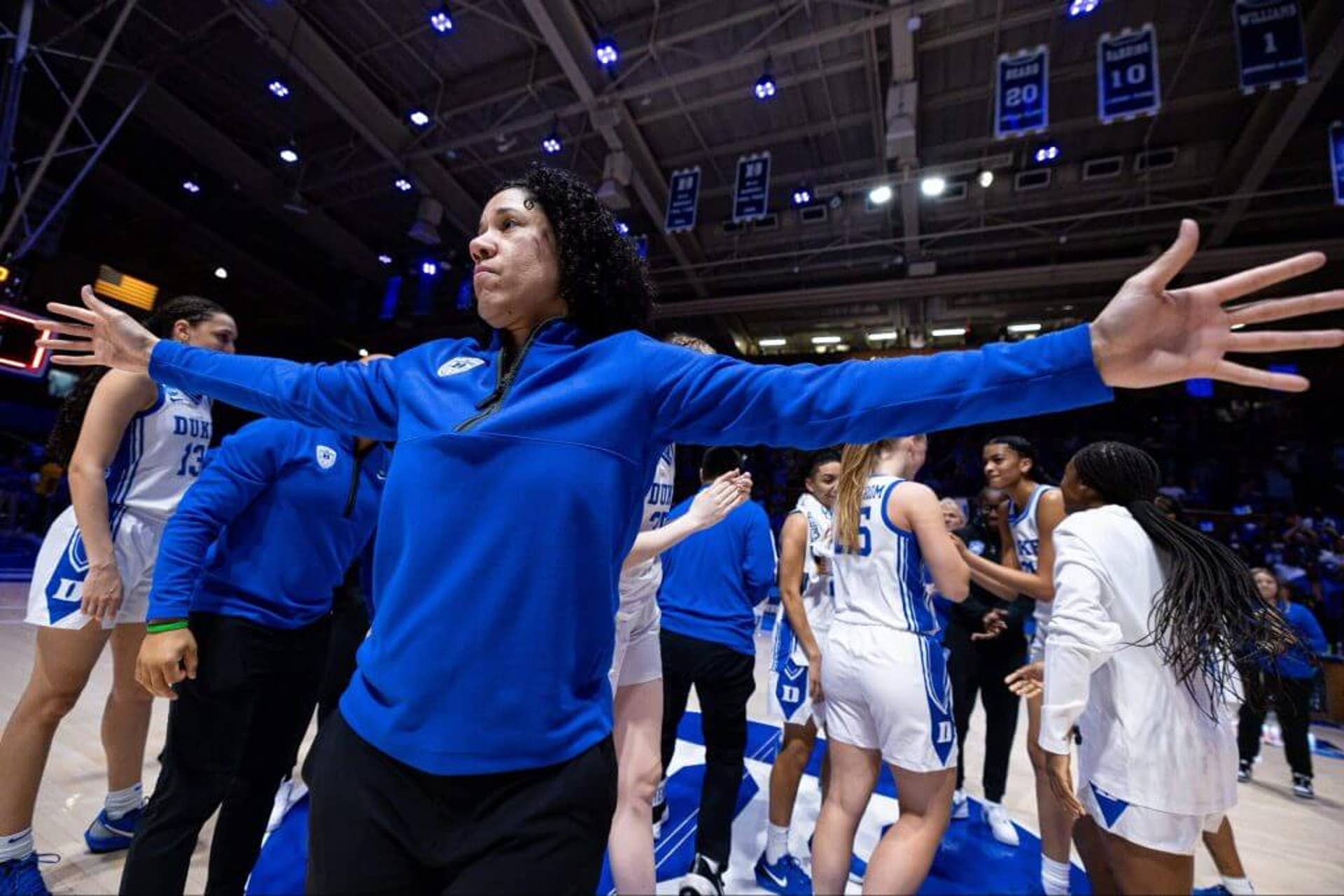 Duke coach Kara Lawson spreads her arms during a timeout.