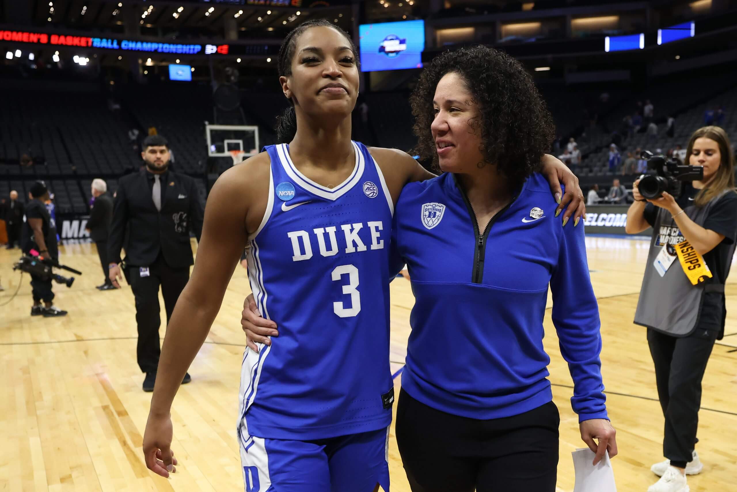 Ashlon Jackson and coach Kara Lawson share a moment of joy after the Blue Devils' victory. (Harry How / Getty Images)