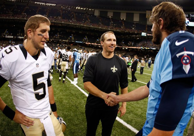 Drew Brees #9 of the New Orleans Saints shakes hands with Zach Mettenberger #7 of the Tennessee Titans as Logan Kilgore #5 looks on during a preseason game between the New Orleans Saints and the Tennessee Titans at Mercedes-Benz Superdome on August 15, 2014 in New Orleans, Louisiana. (Photo by Sean Gardner/Getty Images)