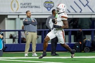 Miami defensive back Keionte Scott (0) intercepts a pass and returns it for a touchdown...
