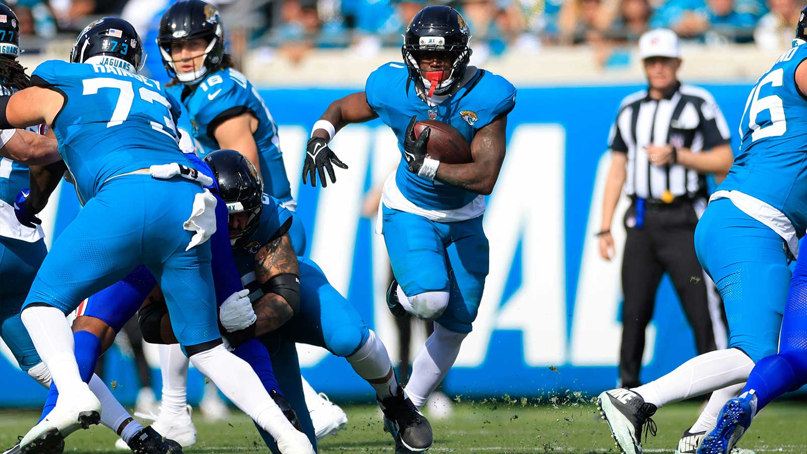Jacksonville Jaguars running back Travis Etienne Jr. (1) rushes for yards during the first quarter of an NFL football AFC Wild Card playoff matchup, Sunday, Jan. 11, 2026, in Jacksonville, Fla.