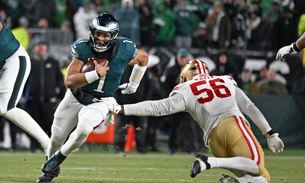 Jan 11, 2026; Philadelphia, PA, USA; Philadelphia Eagles quarterback Jalen Hurts (1) runs past San Francisco 49ers defensive end Keion White (56) in an NFC Wild Card Round game at Lincoln Financial Field.
