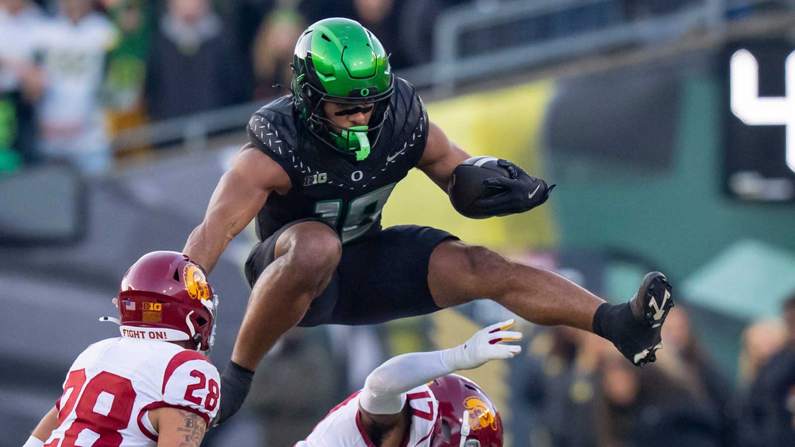 Oregon tight end Kenyon Sadiq hurdles over USC cornerback DeCarlos Nicholson as the Oregon Ducks host the USC Trojans on Nov. 22, 2025, at Autzen Stadium in Eugene, Oregon.