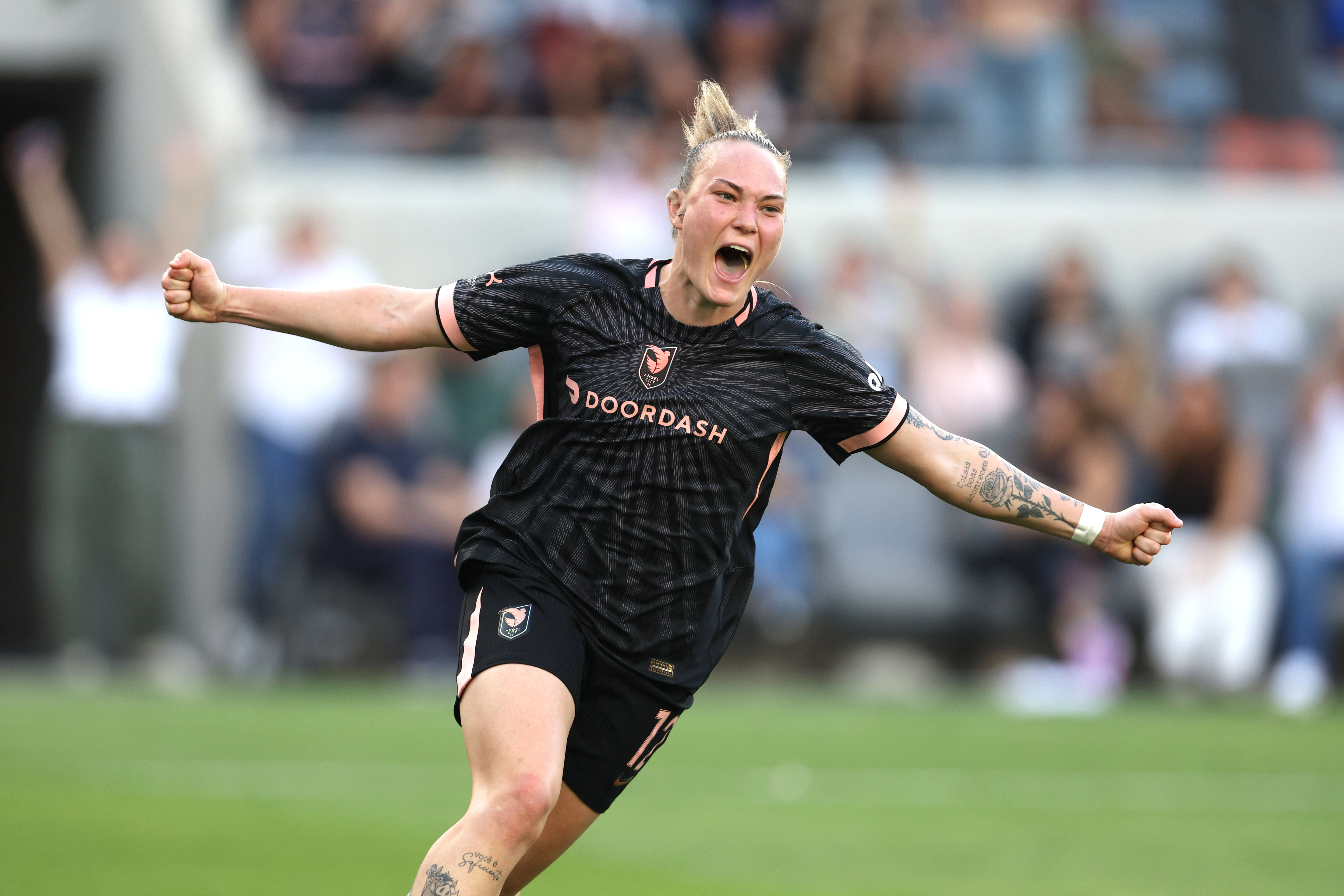 Angel City FC midfielder Maiara Niehues (12) celebrates after scoring...