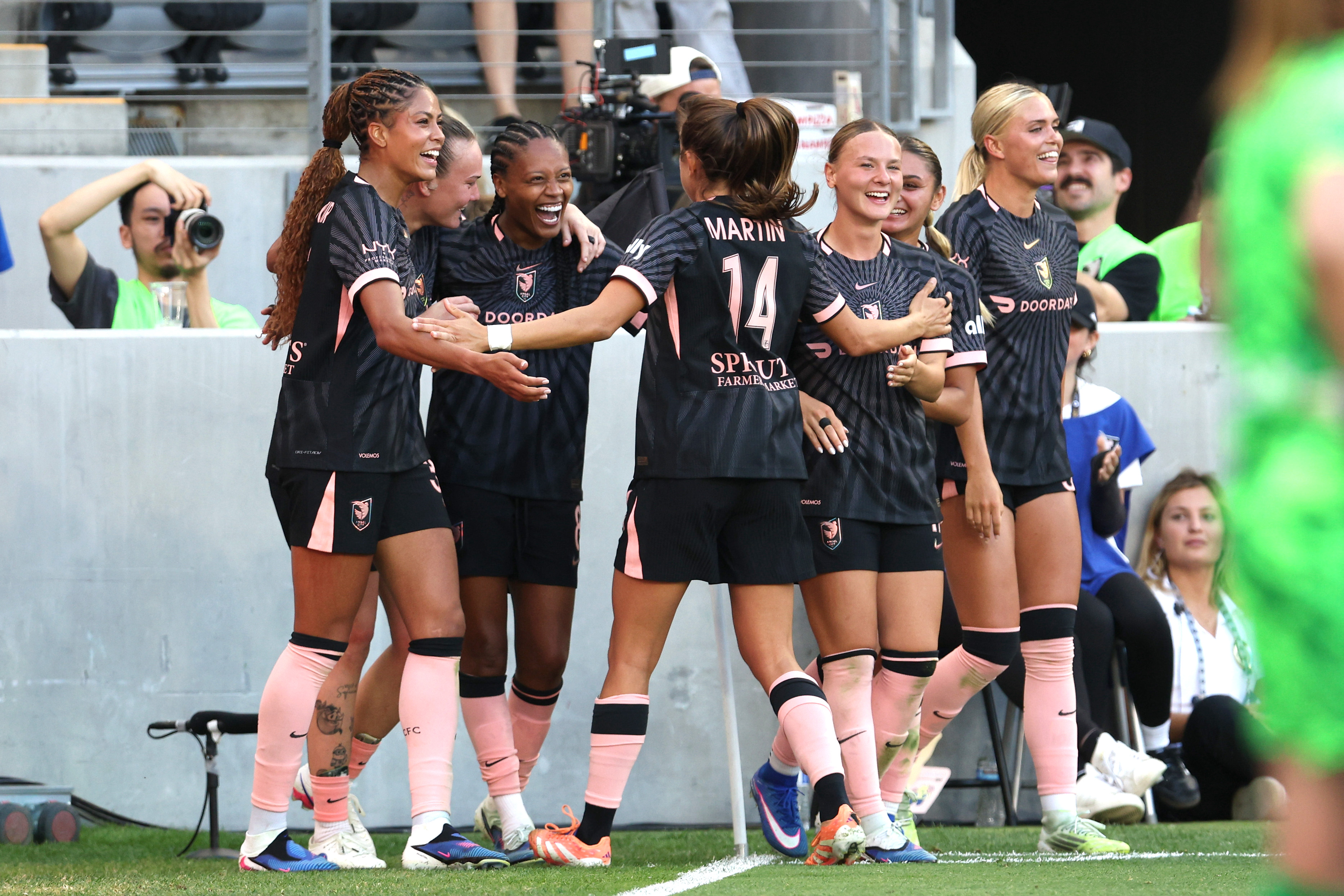 Angel City FC midfielder Ary Borges, second from left, celebrates...