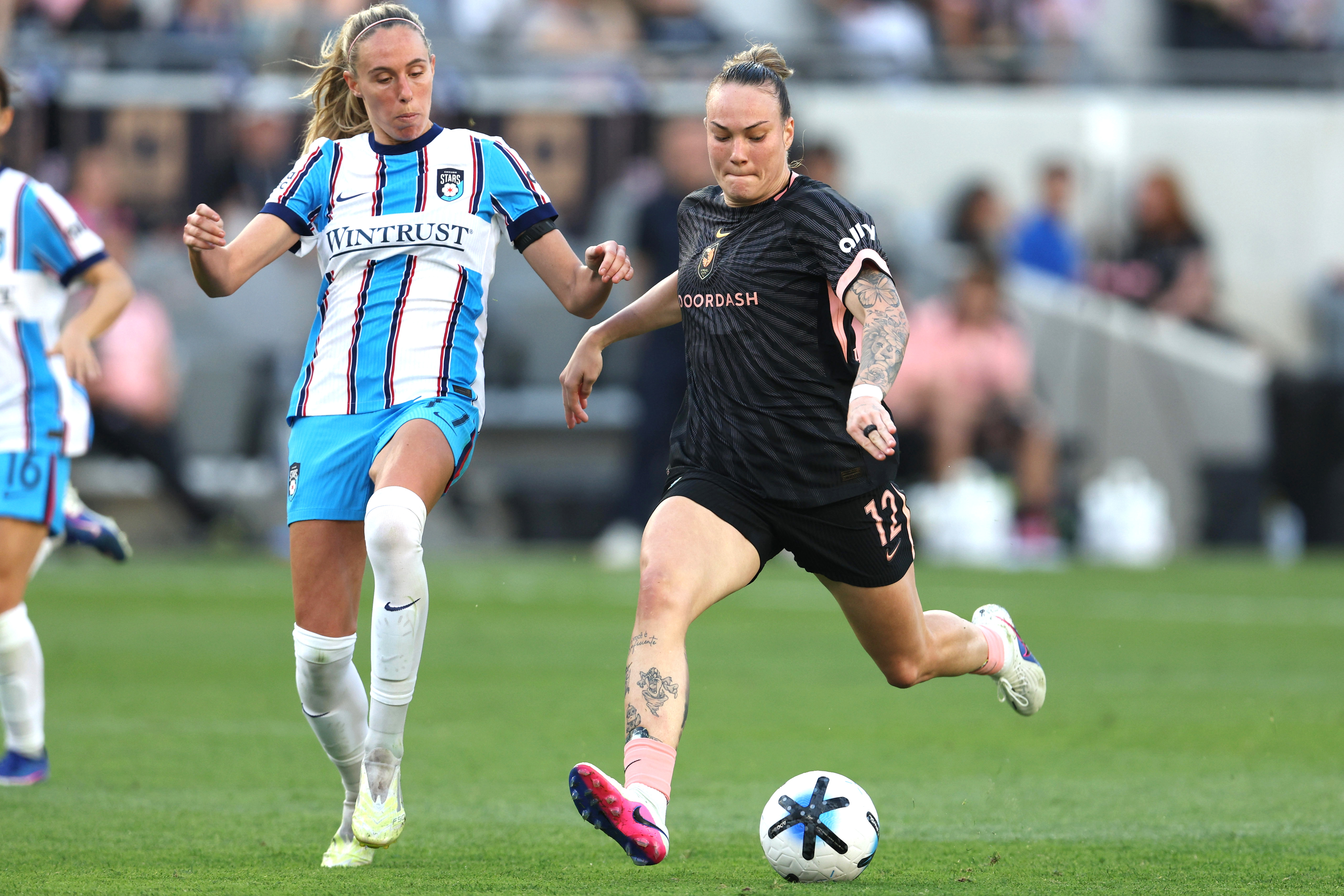 Angel City FC midfielder Maiara Niehues, right, controls the ball...