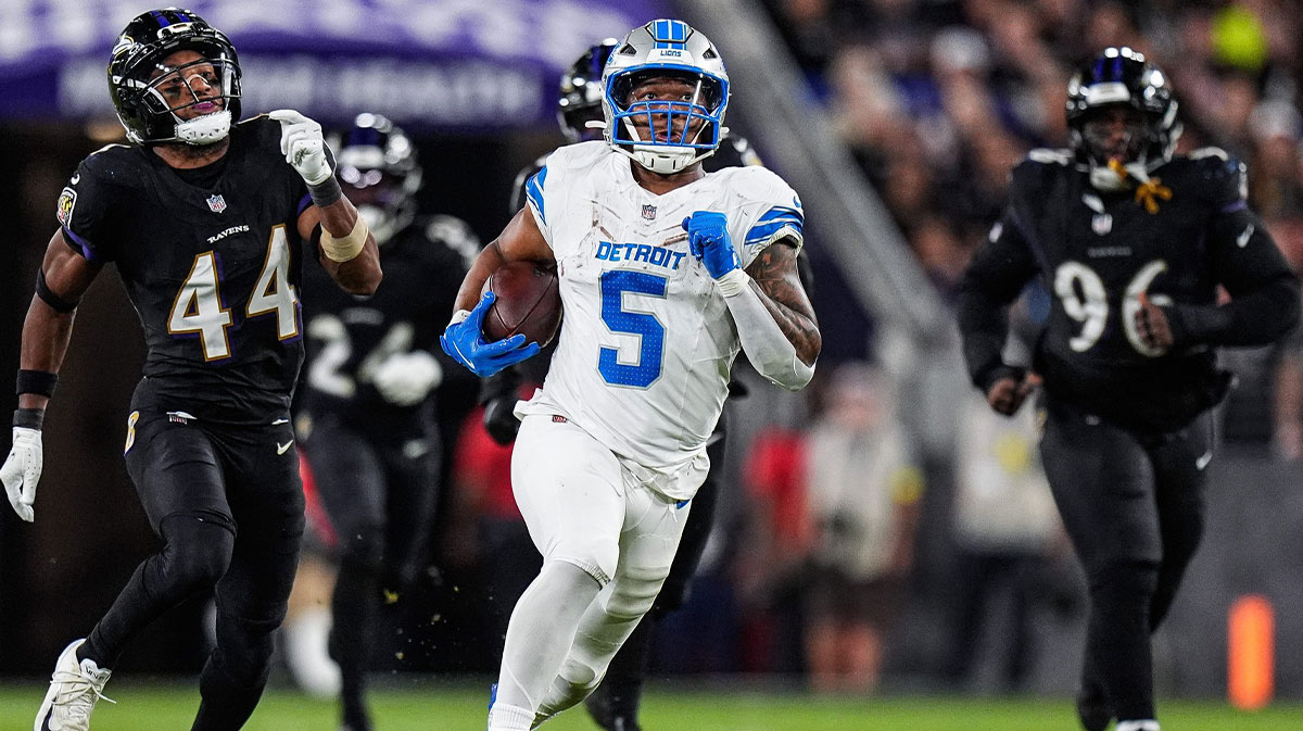 Detroit Lions running back David Montgomery (5) runs against Baltimore Ravens cornerback Marlon Humphrey (44) and defensive tackle Broderick Washington (96) during the second half.