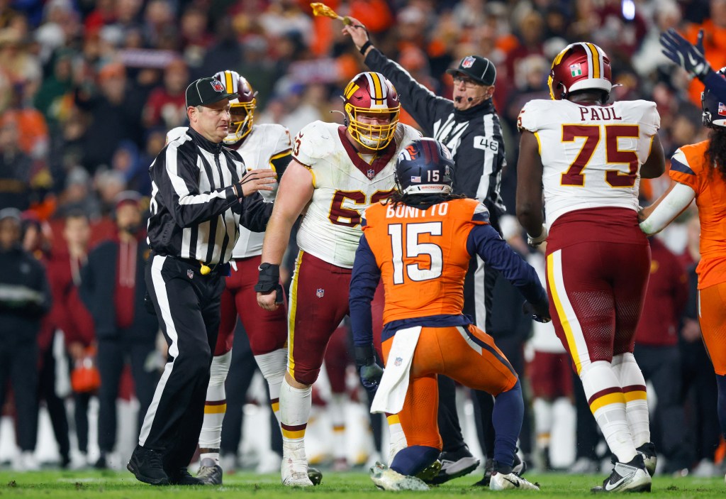 Washington Commanders center Tyler Biadasz exchanges words with Denver Broncos linebacker Nik Bonitto.