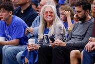 Dallas Mavericks owner Miriam Adelson, center, sits courtside during the second half of an...