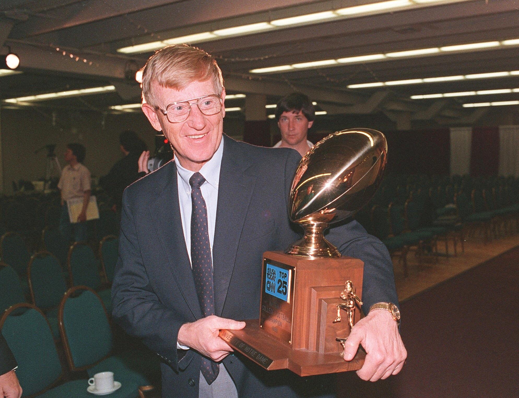 FILE – Notre Dame head coach Lou Holtz carries away...