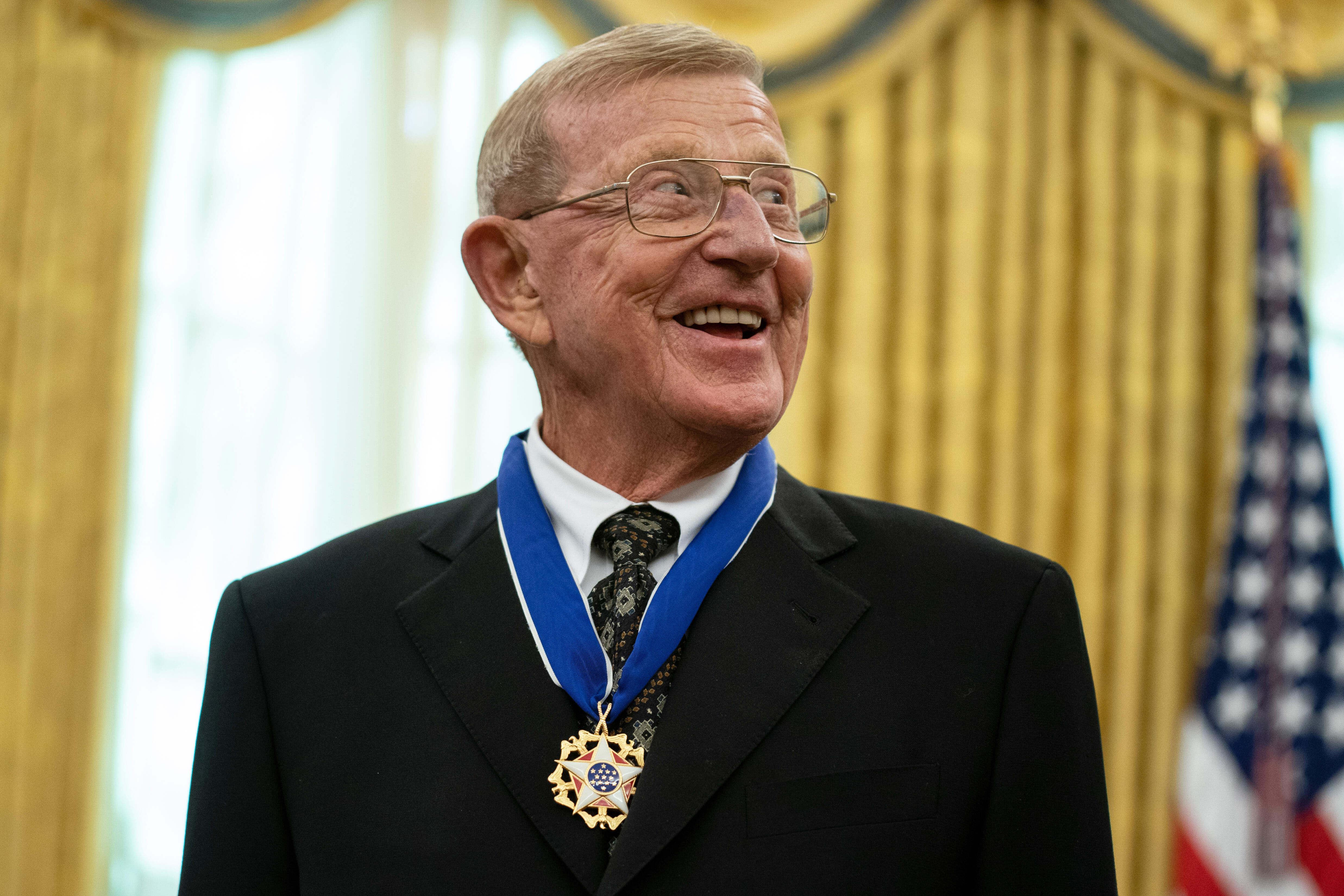 FILE – Former football coach Lou Holtz smiles after receiving...