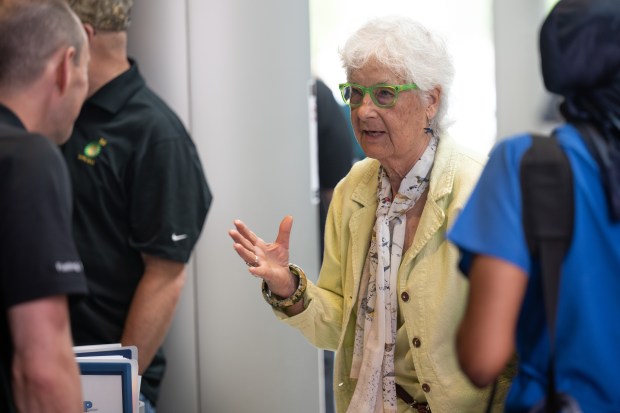 Whiting resident Carolyn Marsh, admin of the BP Whiting Watch Facebook page, speaks with BP employees during the BP Whiting Refinery community night event on Thursday, June 20, 2024. (Kyle Telechan/for the Post-Tribune)