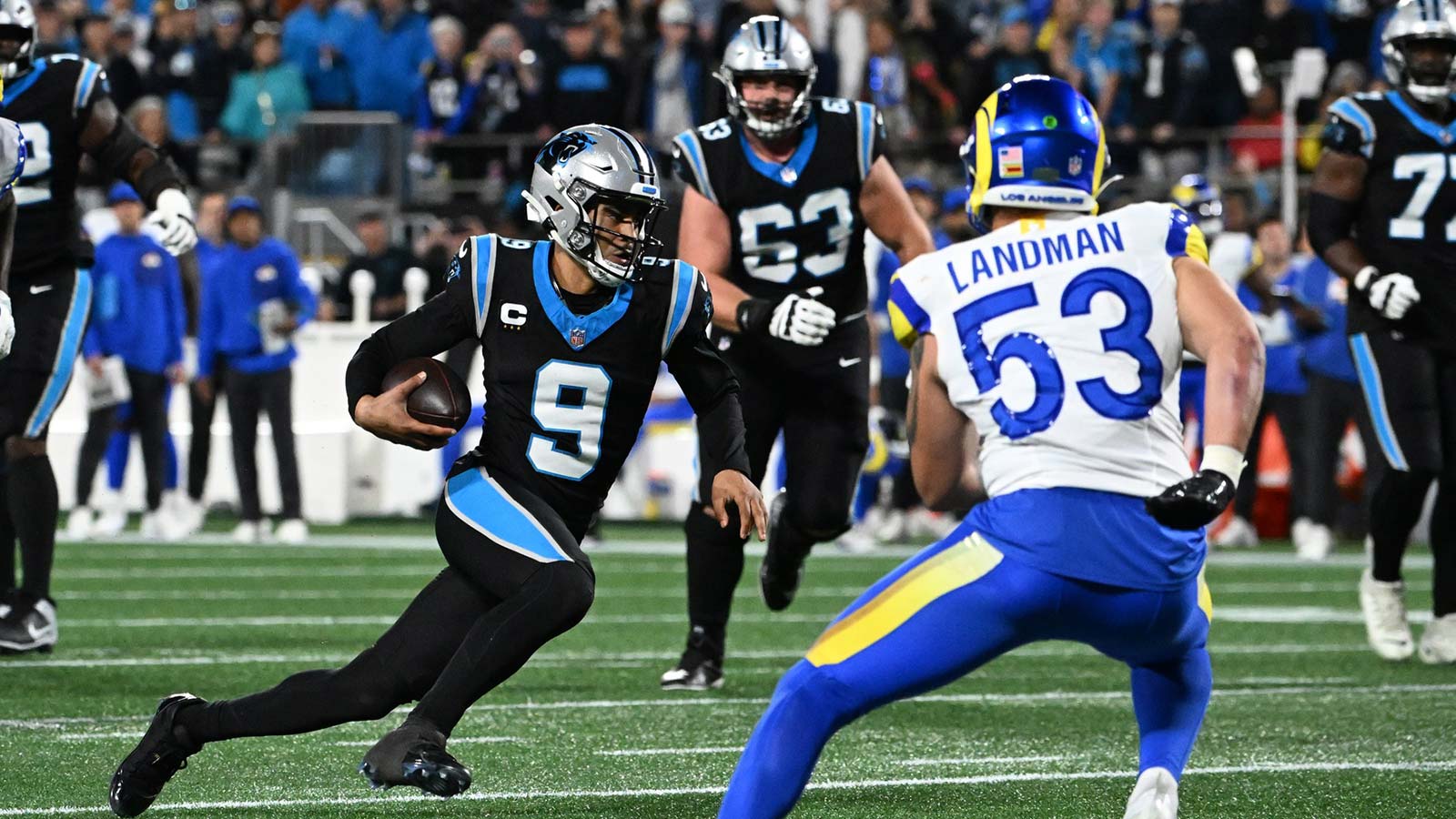 Carolina Panthers quarterback Bryce Young (9) rushes the ball against Los Angeles Rams linebacker Nate Landman (53) in the first half during the NFC Wild Card Round game at Bank of America Stadium.