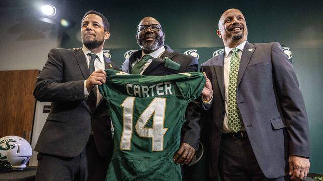 New Sacramento State football coach Alonzo Carter stands alongside university president Luke Wood, left, and athletic director Mark Orr during his introductory news conference on Dec. 18, 2025.