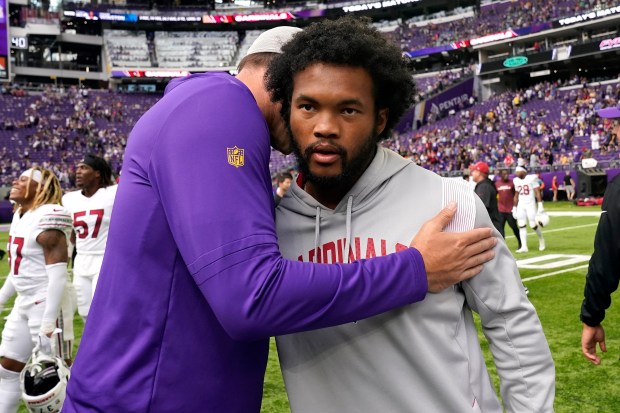 Kevin O'Connell embraces Kyler Murray.