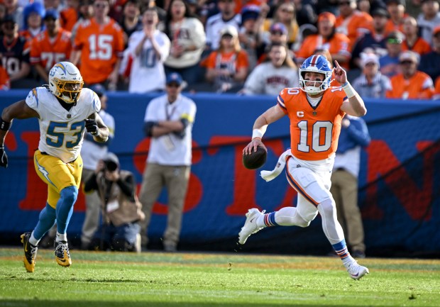 Bo Nix (10) of the Denver Broncos scrambles as Del'shawn Phillips (53) of the Los Angeles Chargers chases him during the first quarter at Empower Field at Mile High in Denver, Colorado on Sunday, January 4, 2026. (Photo by AAron Ontiveroz/The Denver Post)