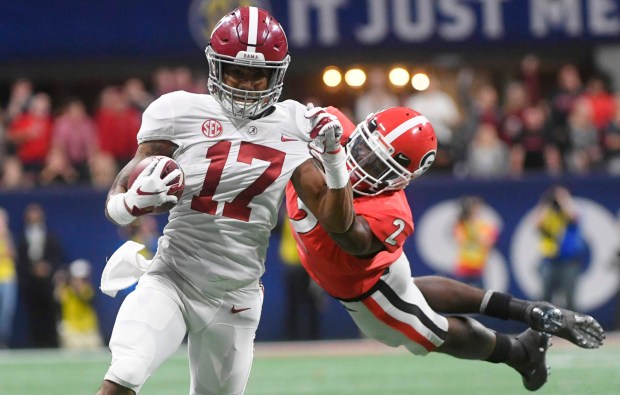 Georgia defensive back Richard LeCounte (2) misses the tackle on Alabama wide receiver Jaylen Waddle (17) during the second half of the Southeastern Conference championship game, Saturday, Dec. 1, 2018, in Atlanta. Waddle scored a touchdown on the play. (AP Photo/John Amis)
