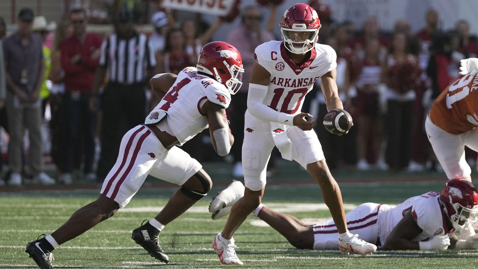 Arkansas Razorbacks quarterback Taylen Green (10) hands the ball off to running back Mike Washington Jr. (4) during the first half against the Texas Longhorns at Darrell K Royal-Texas Memorial Stadium.
