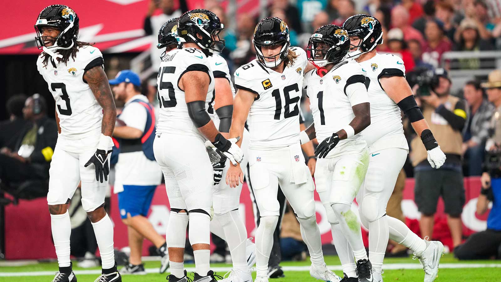 Jacksonville Jaguars running back Travis Etienne Jr. (1) celebrates with Jacksonville Jaguars quarterback Trevor Lawrence (16) after scoring a touchdown during the first quarter against the Arizona Cardinals at State Farm Stadium.