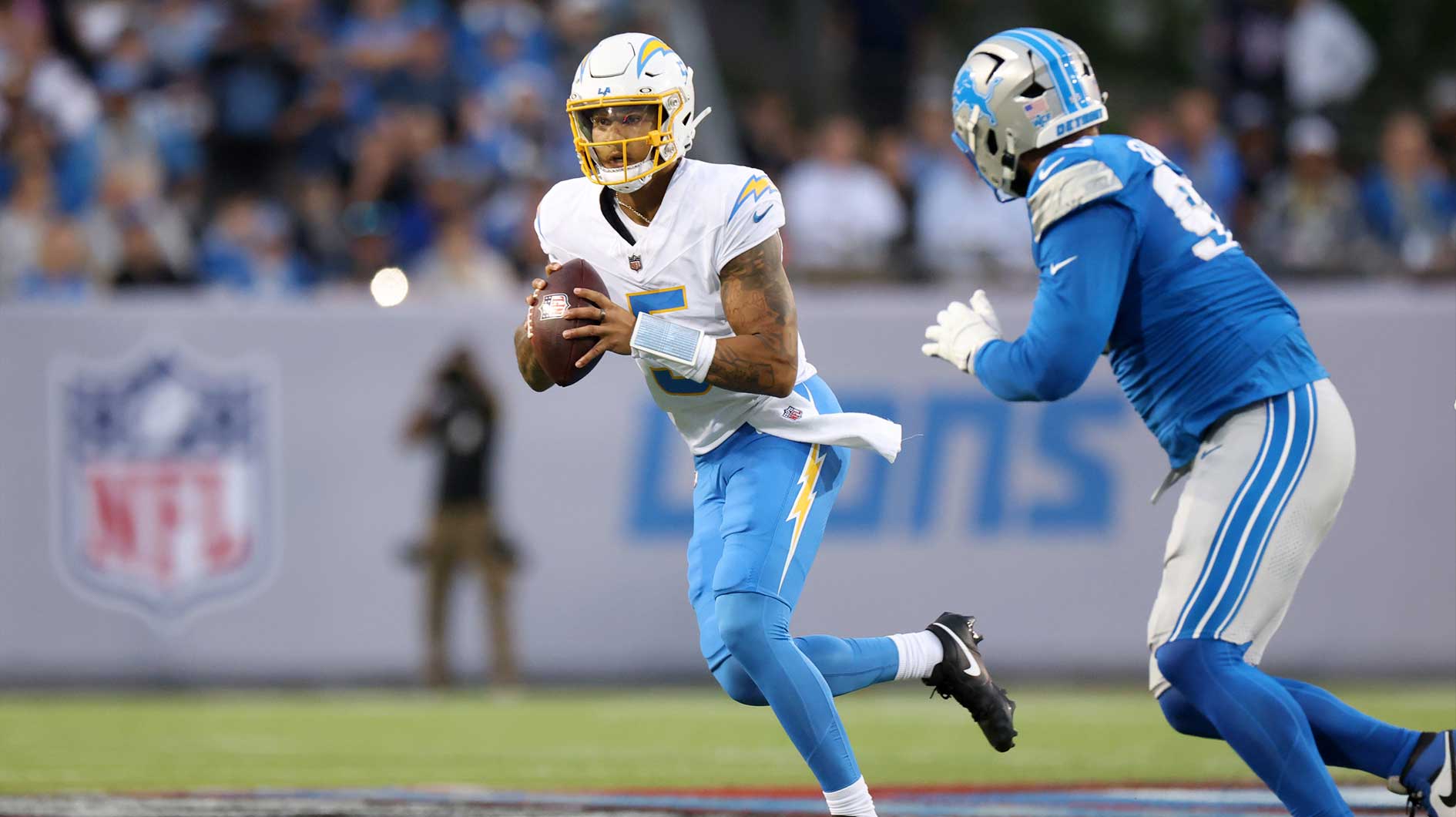 Los Angeles Chargers quarterback Trey Lance (5) looks to pass against the Detroit Lions in the first quarter at Tom Benson Hall of Fame Stadium.
