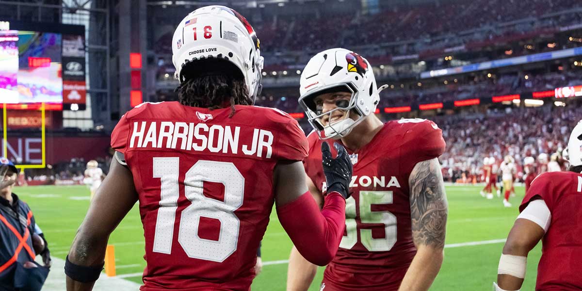 Arizona Cardinals wide receiver Marvin Harrison Jr. (18) celebrates a touchdown with tight end Trey McBride (85) against the San Francisco 49ers in the second half at State Farm Stadium.