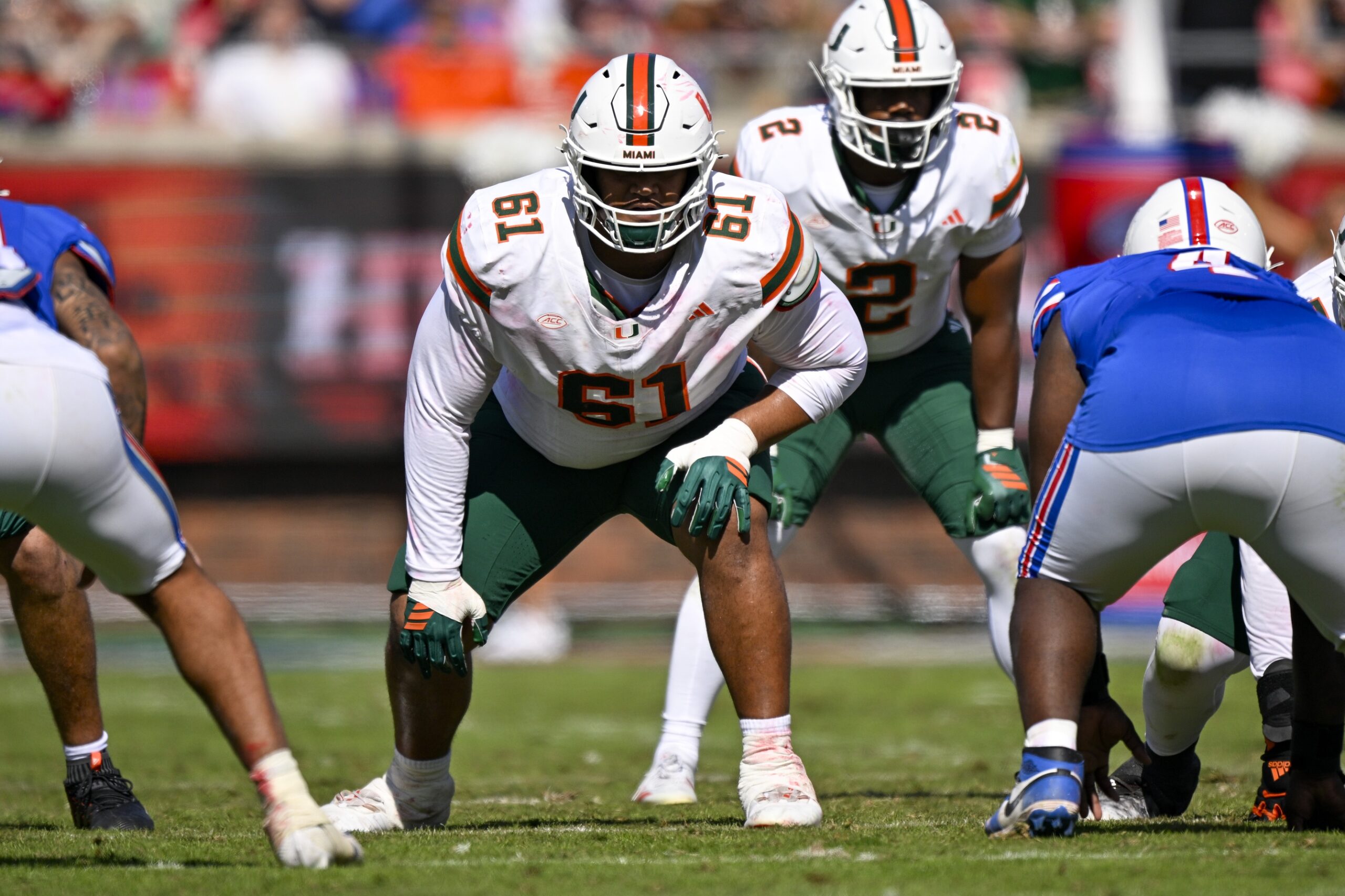 Nov 1, 2025; Dallas, Texas, USA; Miami Hurricanes offensive lineman Francis Mauigoa (61) gets into position during the game between the Mustangs and the Hurricanes at Gerald J. Ford Stadium. Mandatory Credit: Jerome Miron-Imagn Images