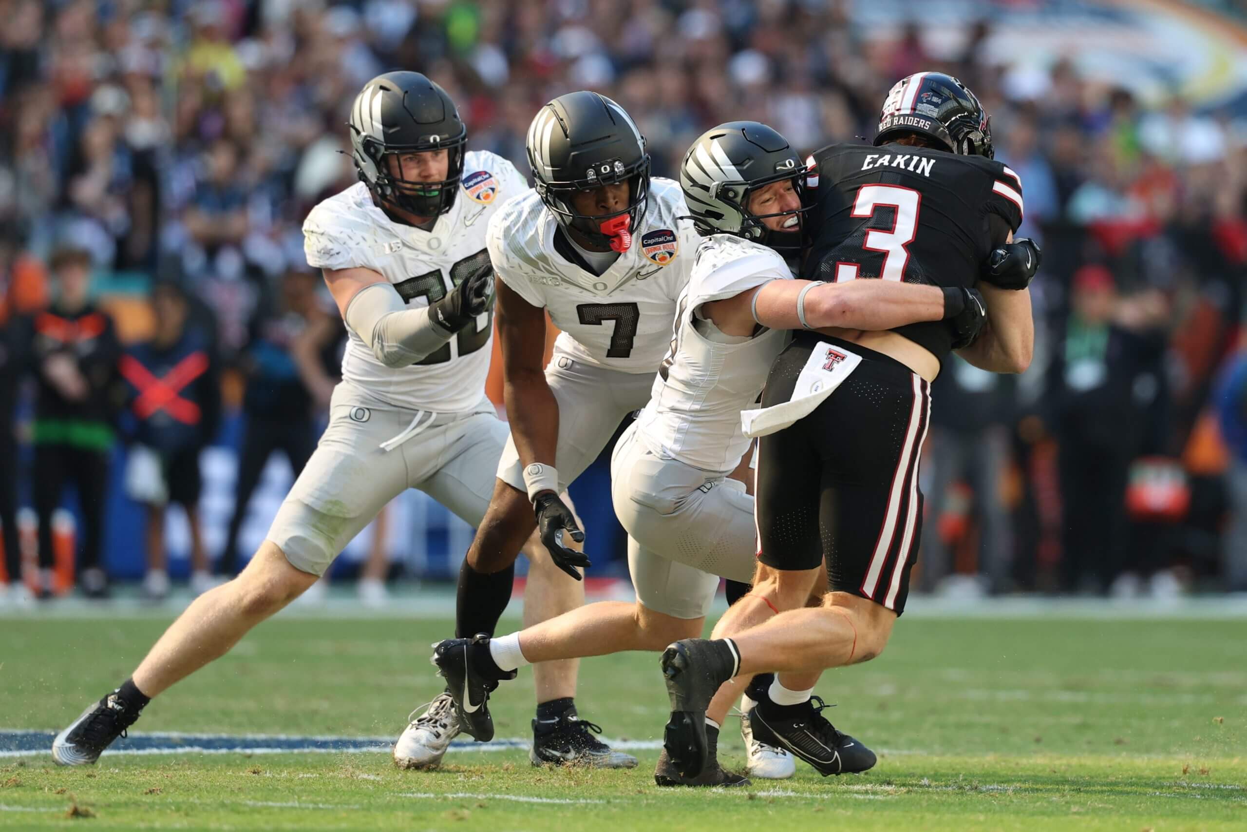 Dillon Thieneman tackles a Texas Tech player with his teammates behind him.
