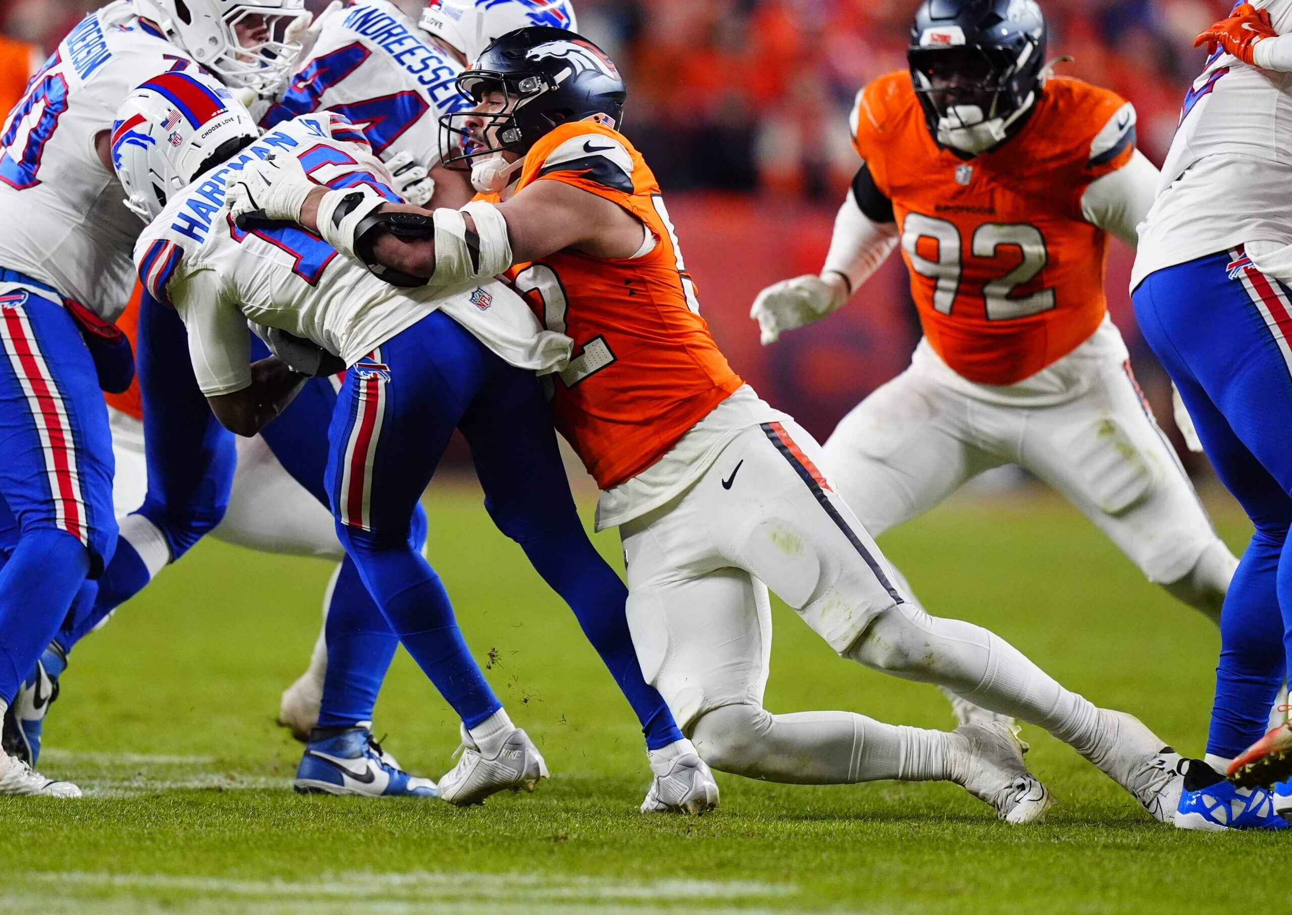 Denver Broncos linebacker Jonah Elliss (52) tackles Buffalo Bills wide receiver Mecole Hardman Jr. (16) during the fourth quarter of an AFC Divisional Round playoff game at Empower Field at Mile High.